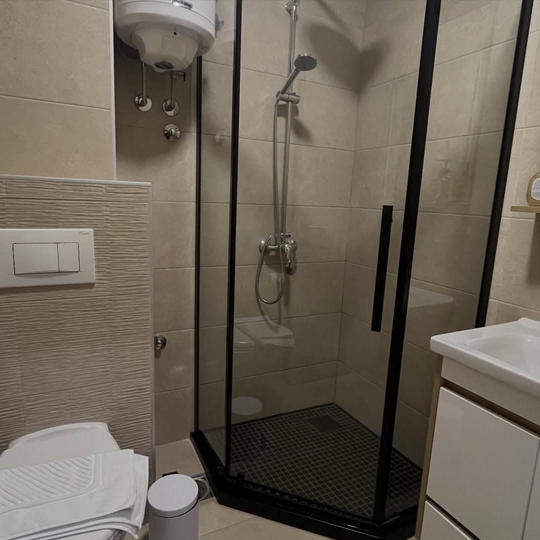 Clean bathroom with shower cabin, toilet and vanity