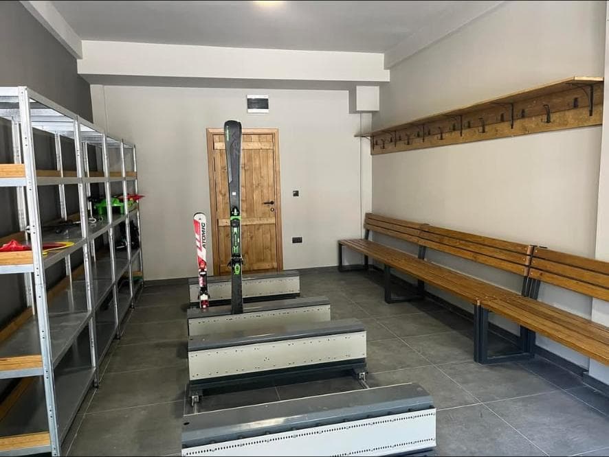 Ski depot on the ground floor with shelves, benches and boot dryers